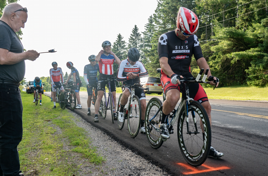 cyclists lined up along a road before race